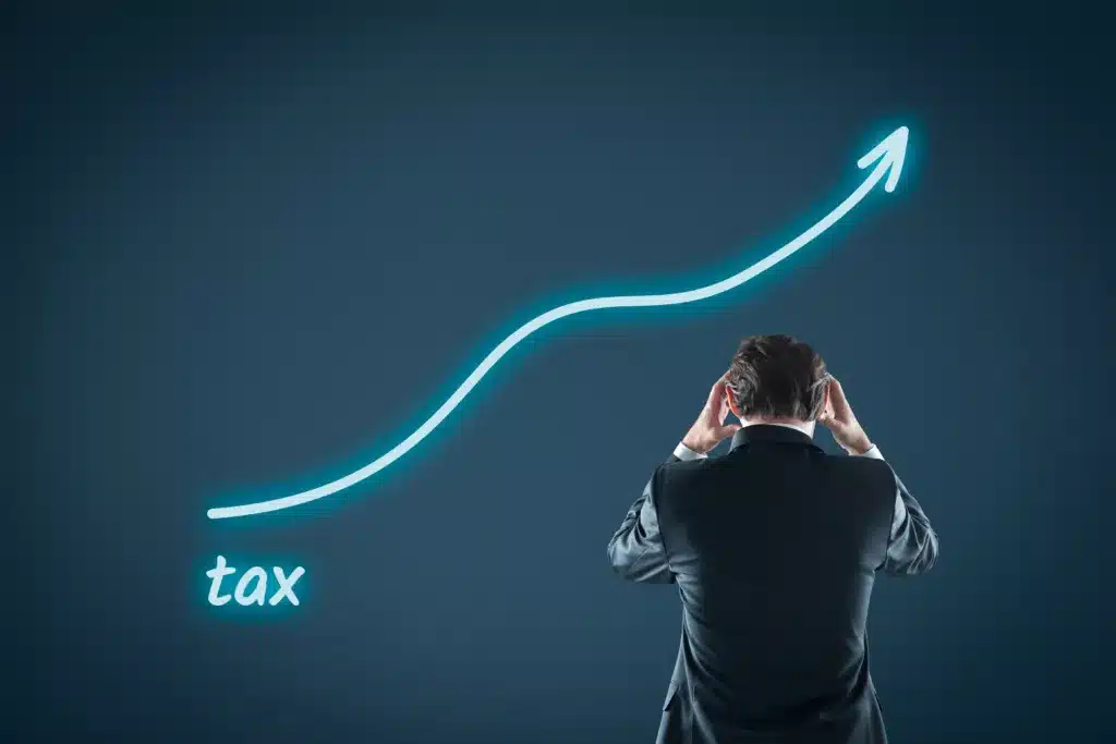 Growing tax burden concept. Businessman is frustrated by unexpected tax increase.