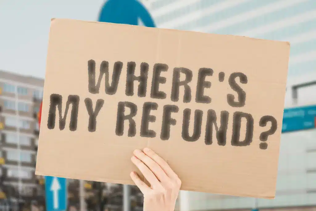 CP05A Notice " Where's My Refund? " is on a banner in men's hands with blurred background. Refund. State. Irs. Payroll. Rebate. Web. Finance. Money. Service. Benefit. Internet. Bank. Return. Cash 