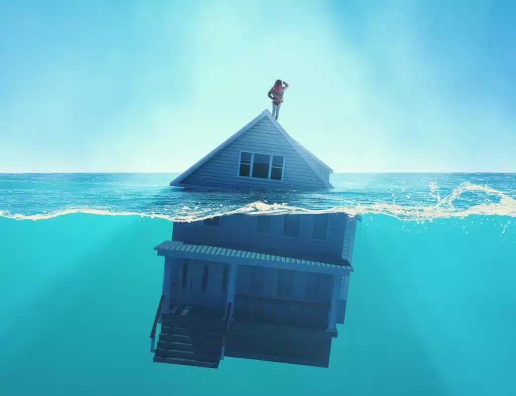 House sinking into the ocean . Half splitted image in the sea of a home floating . Debt and bankruptcy concept . This is a 3d render illustration .