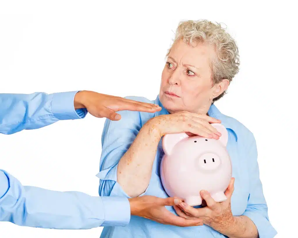Don't levy my pension savings. Senior woman protecting piggy bank
