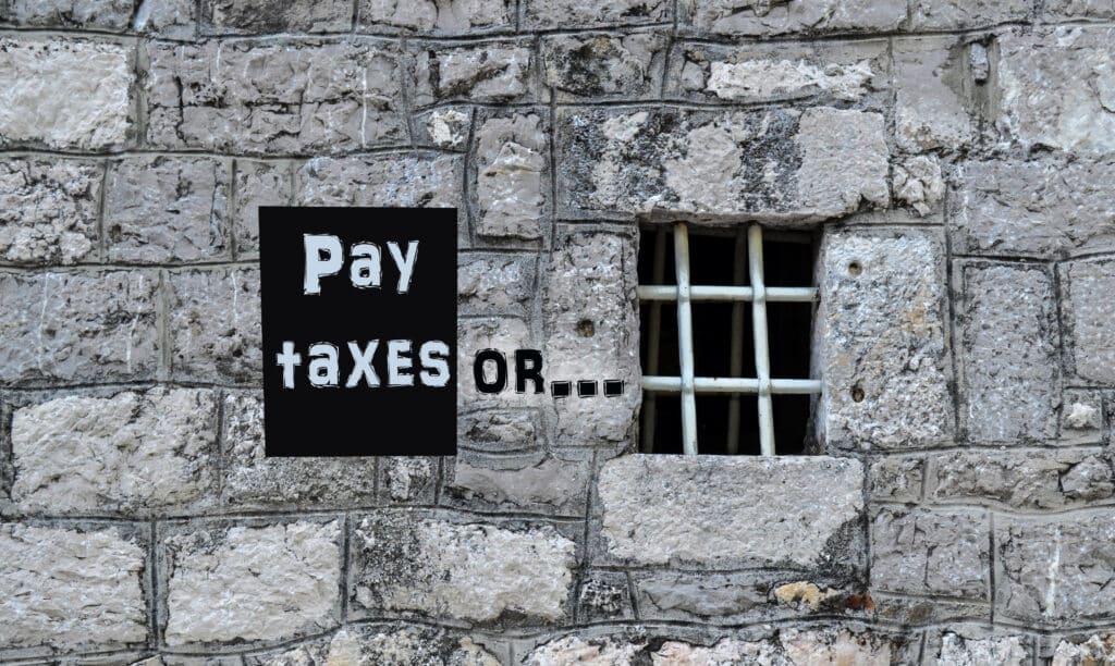 Jail time for not paying taxes. The inscription on the prison wall: pay taxes or ...